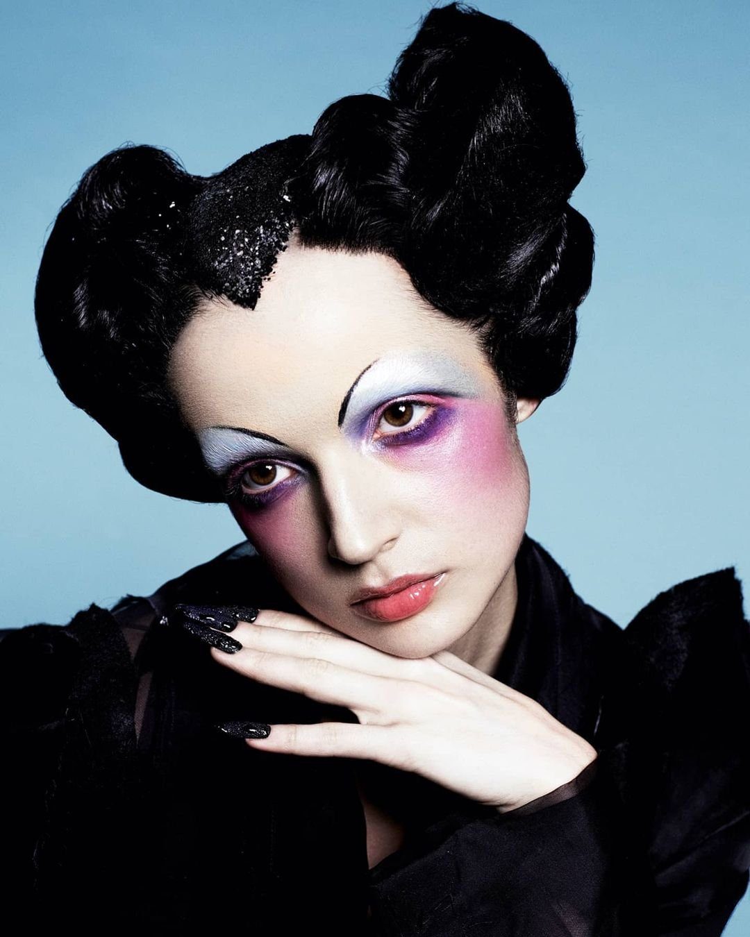 Poppy Beauty campaign portrait: sculpted hair and painted eyes on blue